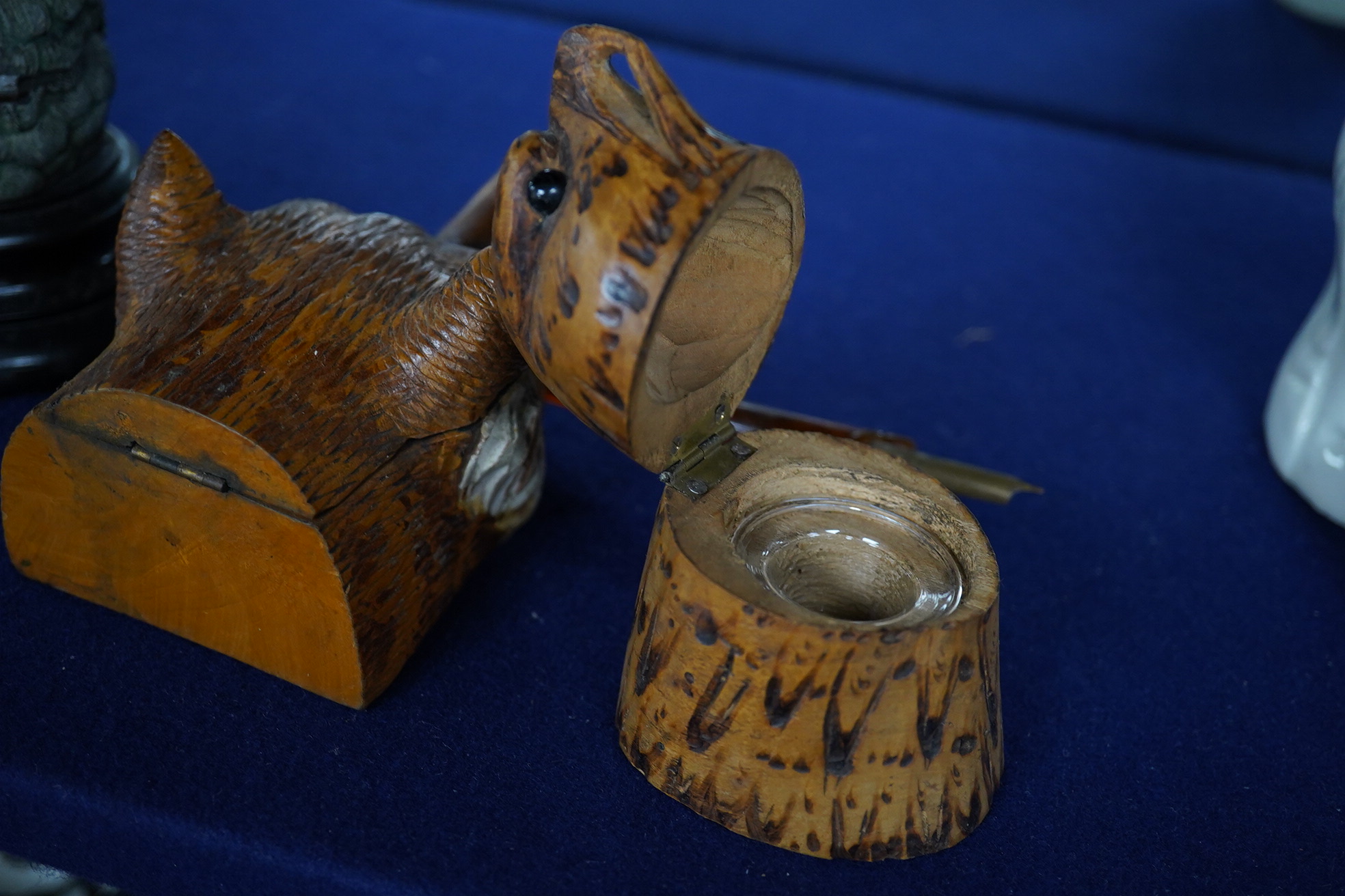 Two carved wood novelty inkwells in the form of animals, one with pen, together with a lead owl inkwell, largest 9cm high. Condition - fair